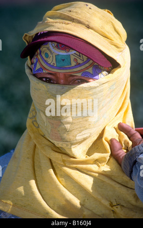 Migrant Farm Worker wrapped in cotton clothing to stay cool.` Stock Photo